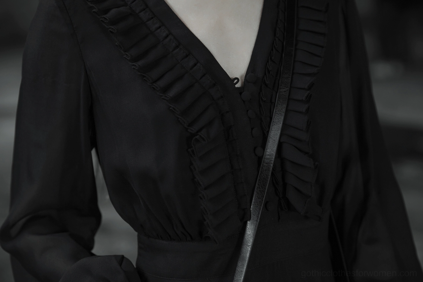 Black asymmetrical chiffon gothic dress detailed view on form showing fitted waist and layered handkerchief hem construction