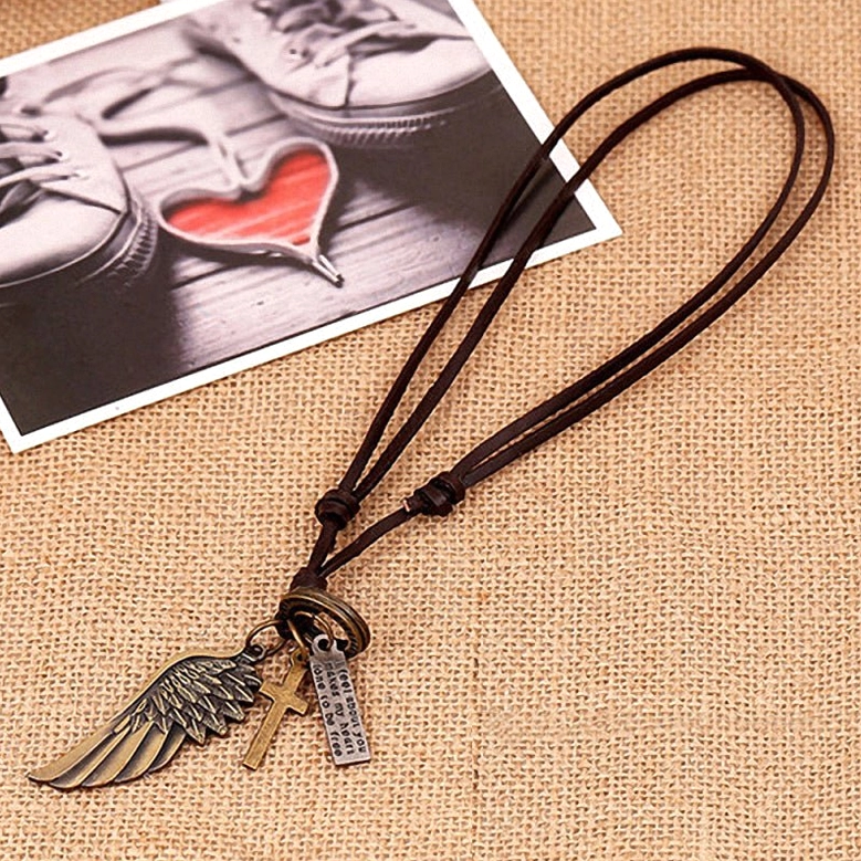 Bronze angel wing and text charm pendants on brown leather adjustable gothic choker, overhead flat lay