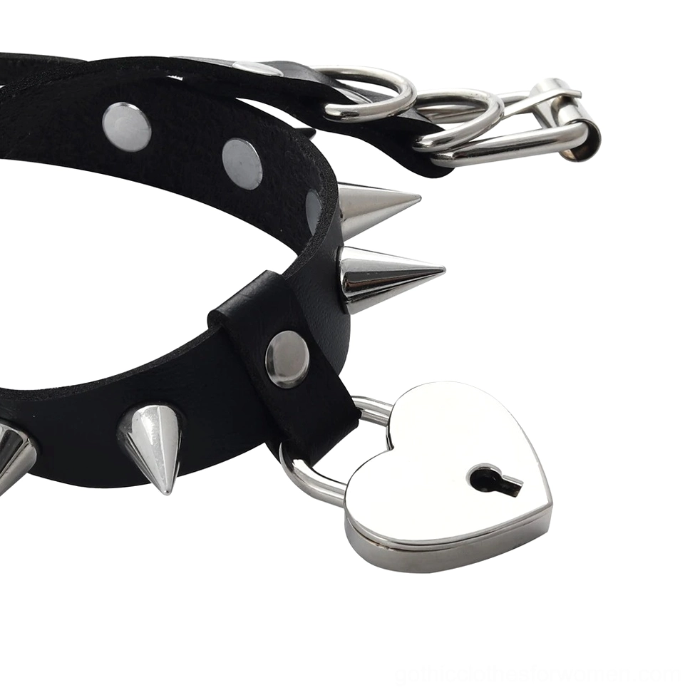 Close-up side view of black leather heart choker showing adjustable buckle holes and spike placement