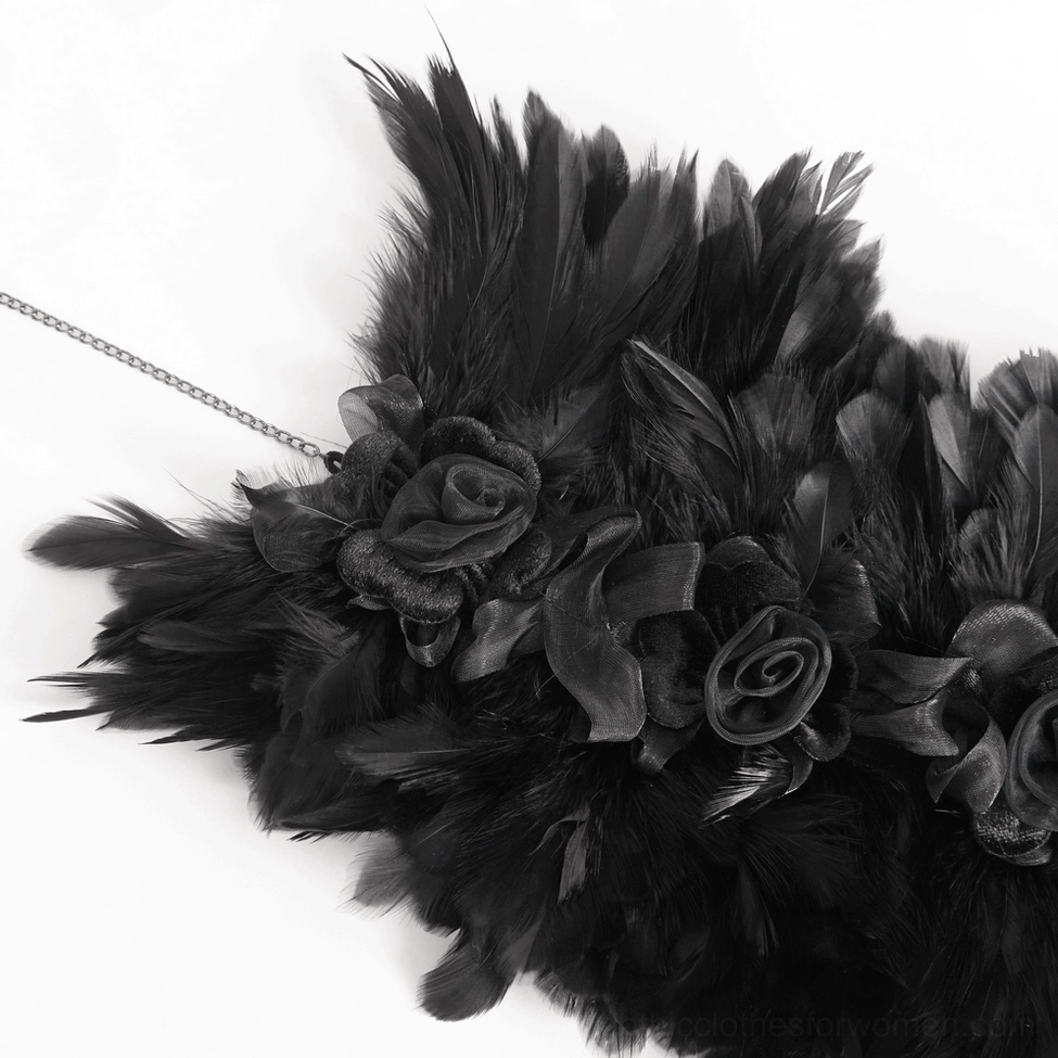 Close-up detail of gothic feather choker with fabric roses and metal chain attachment