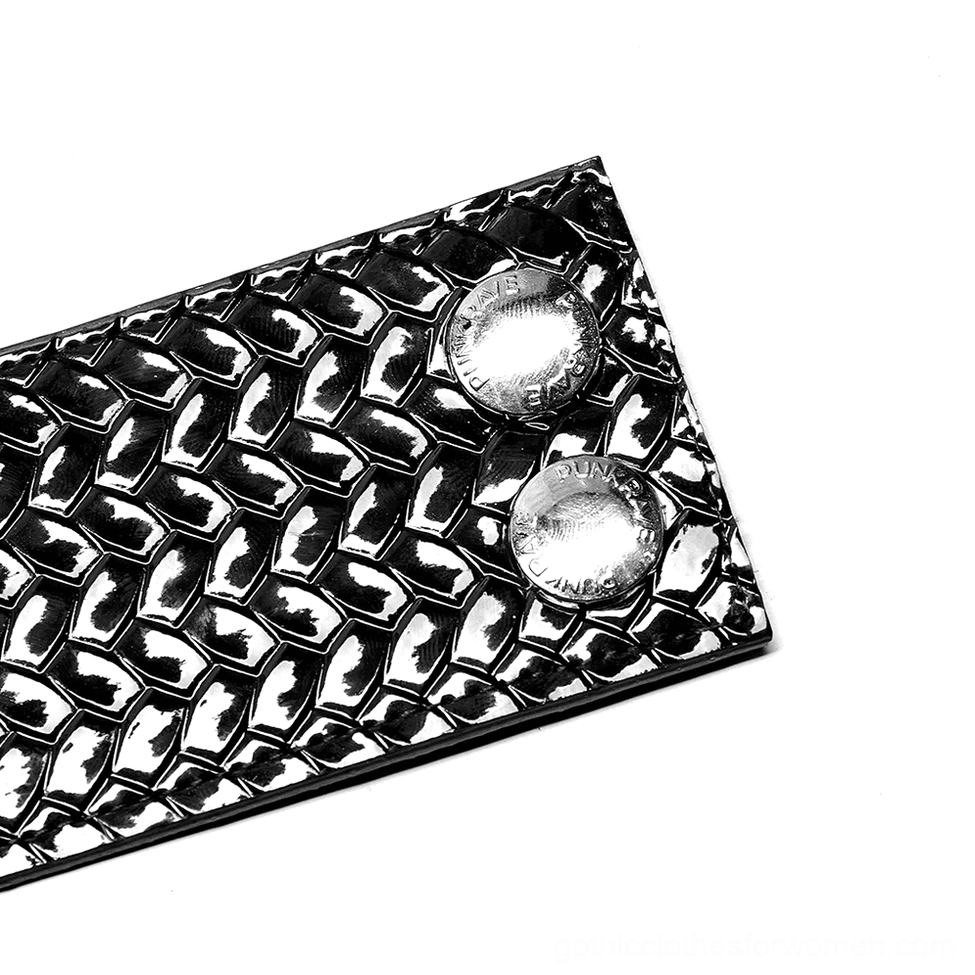 Black python grain choker strap with embossed woven texture and round silver studs, angled flat lay