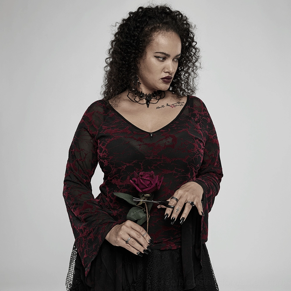 Full-length portrait of model wearing black gothic bird skull choker with dark goth outfit and rose prop
