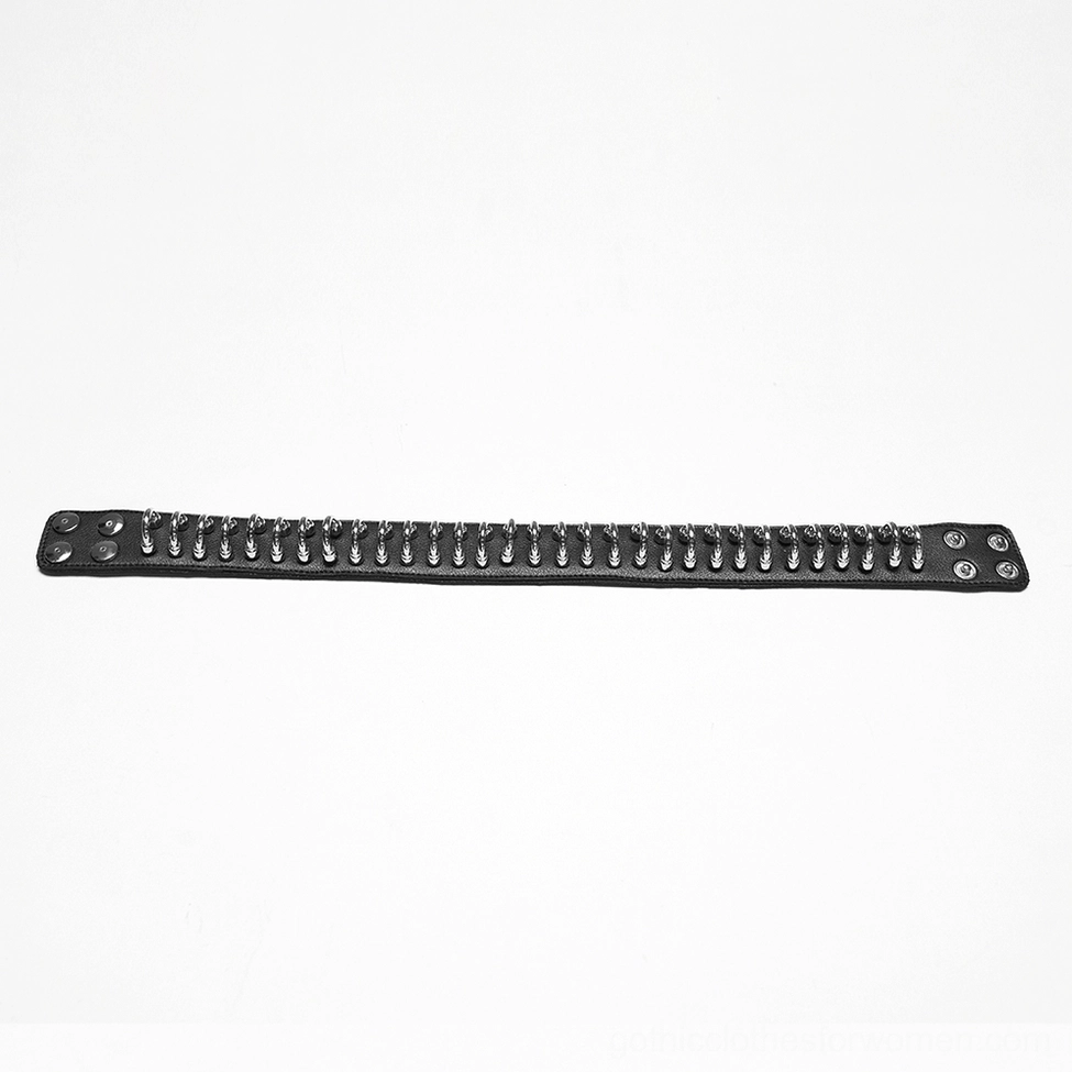 Close-up detail of dense silver metal ring row on black leather gothic choker