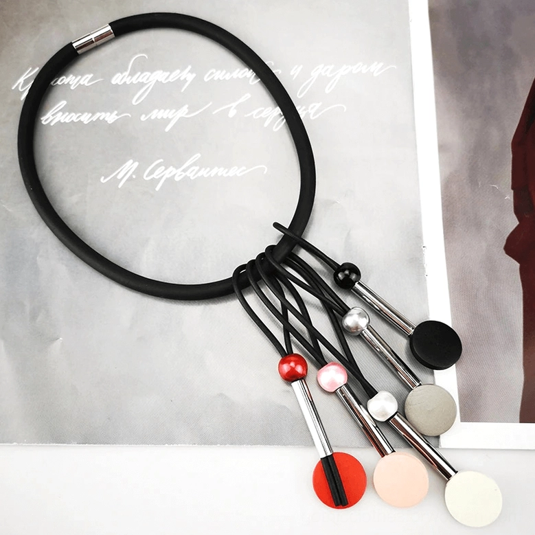 Handmade gothic multicolor beaded choker necklace flat lay with dangling pendants and elastic neck ring