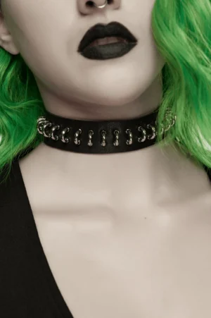 Close-up of black gothic choker necklace on neck showing metal D-rings and snap closure details