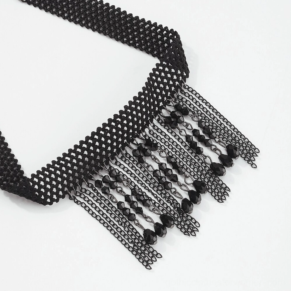 Oblique angle flat lay of black woven choker collar with dangling crystal tassel chains, showcasing textured mesh construction