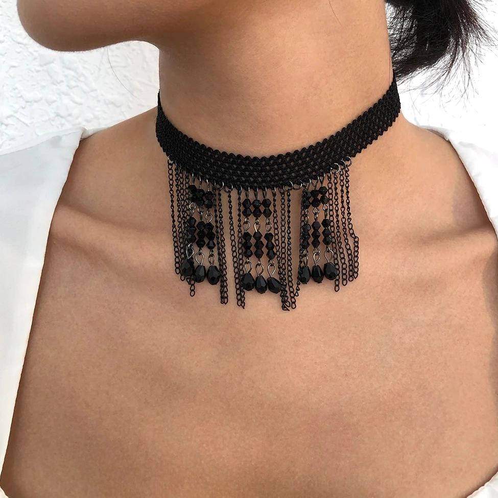 Side front view of black tassel choker on model's neck with half-up hairstyle, highlighting woven strap and black crystal tassel decorations