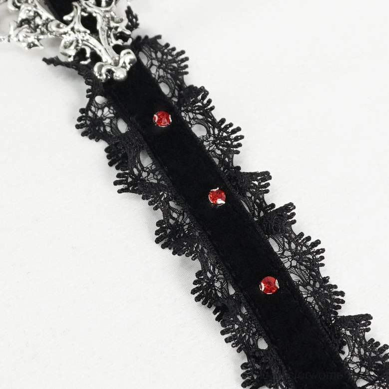 Angled close-up view of gothic choker pendant highlighting red gem embellishments and intricate silver metalwork craftsmanship