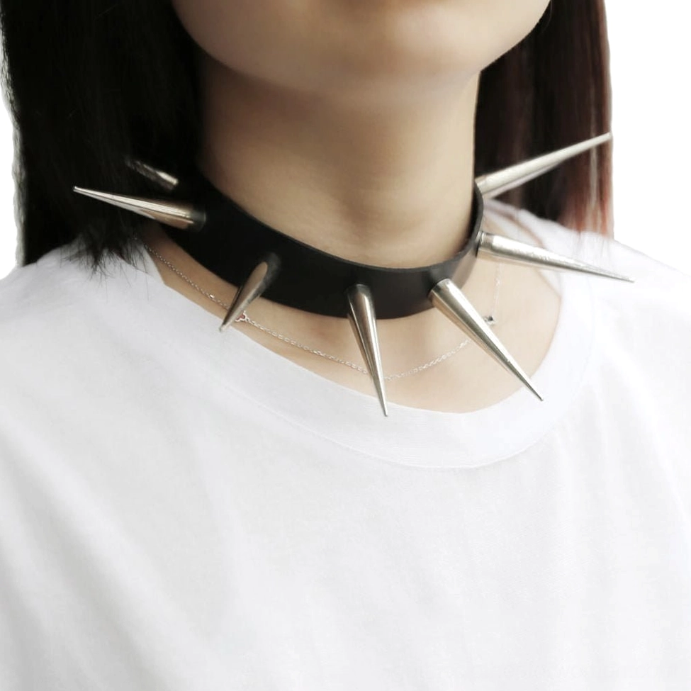 Black studded leather gothic choker with silver metal spikes, worn on model showing close-up detail of spike construction and leather texture