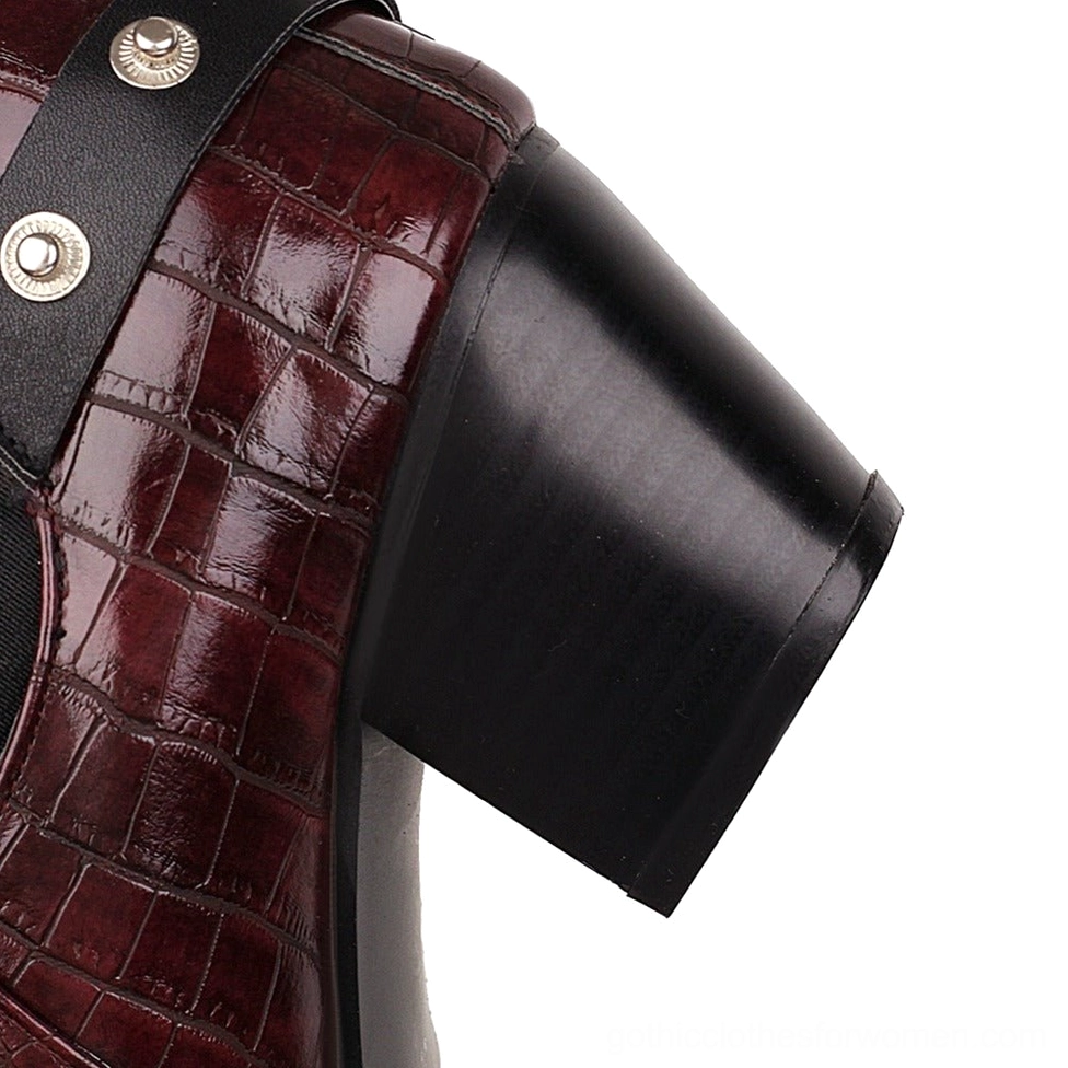 Women's gothic chunky heel ankle boots with decorative buckles and rivets shown in lifestyle context