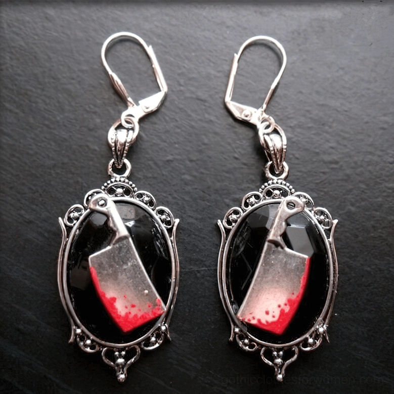 Detailed gothic meat cleaver earrings with black stone and carved vintage metal frame on neutral background
