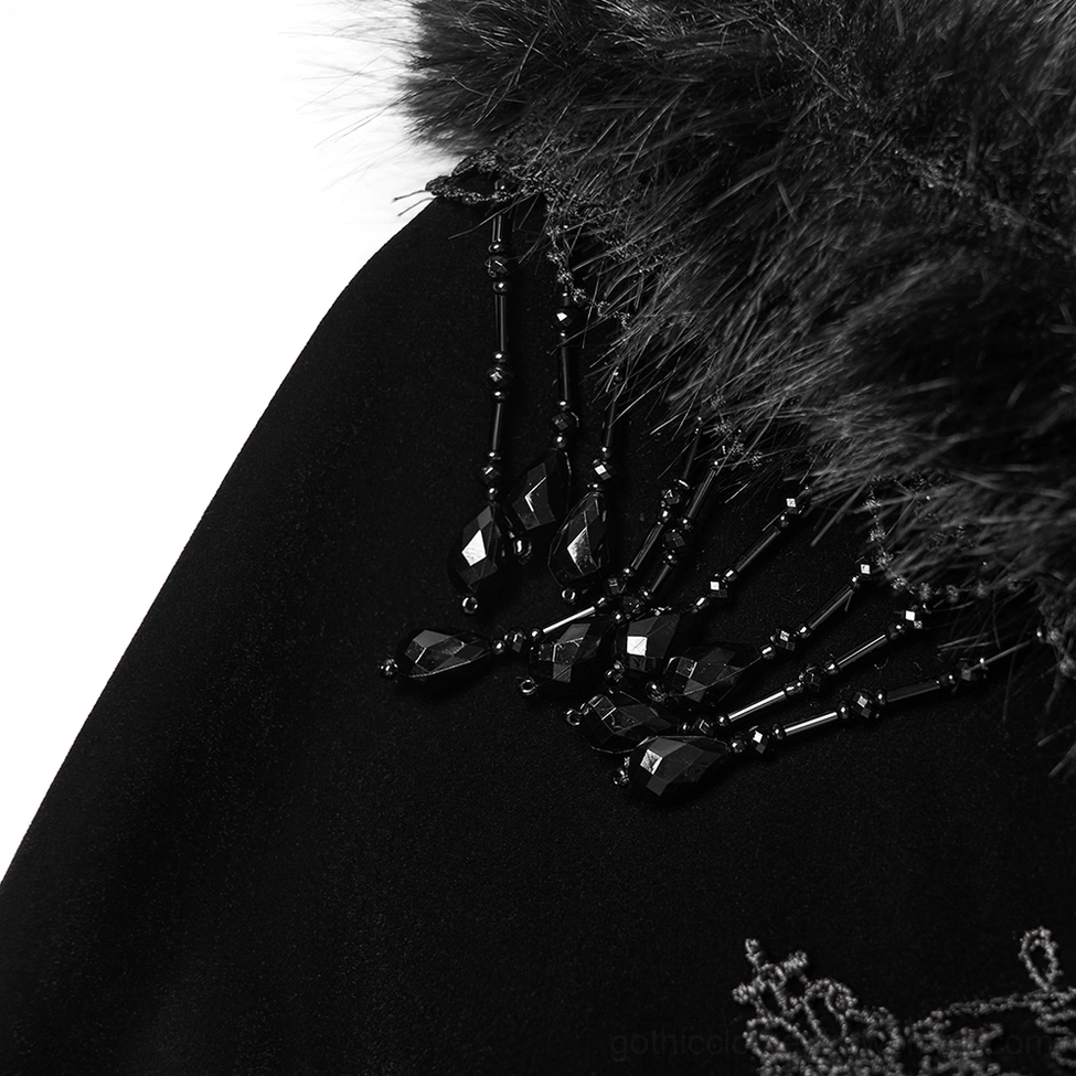 Tassel chain and faux fur trim details on shoulders of black velvet gothic cloak coat