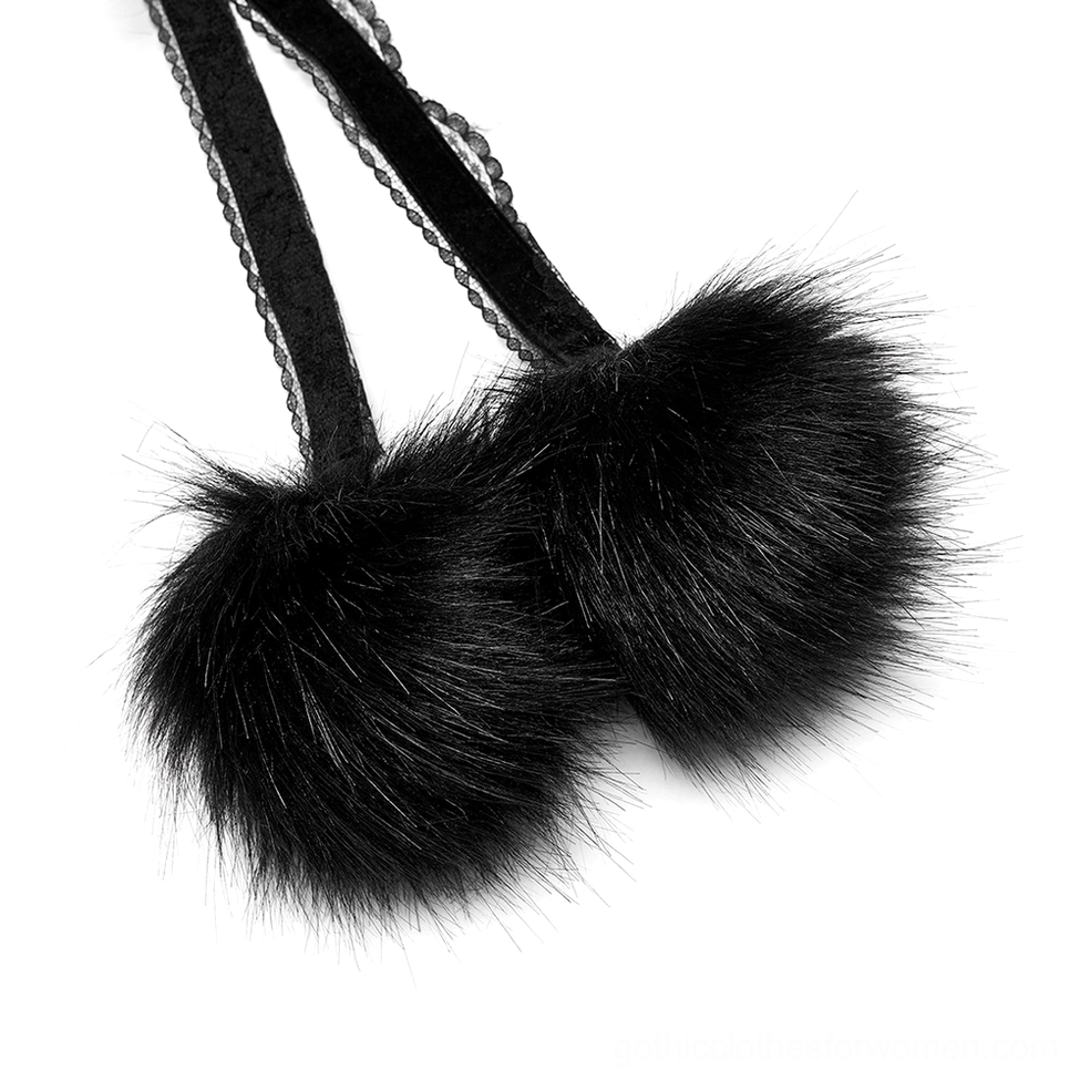 Close-up of Gothic cloak closure straps featuring black faux fur pom-poms and lace details