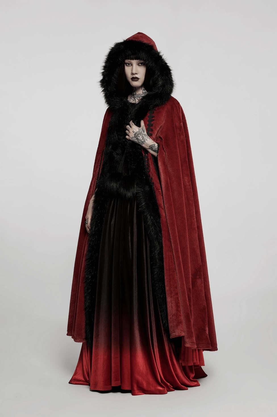 Crimson gothic faux fur cloak detail shot showing velvet texture and black fur trim craftsmanship