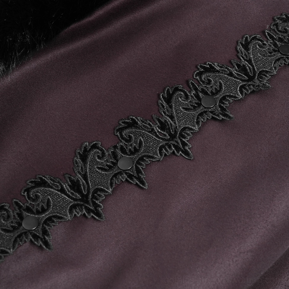 Close-up detail of vintage floral lace appliqué on gothic cloak with metal snap buttons and dark fabric