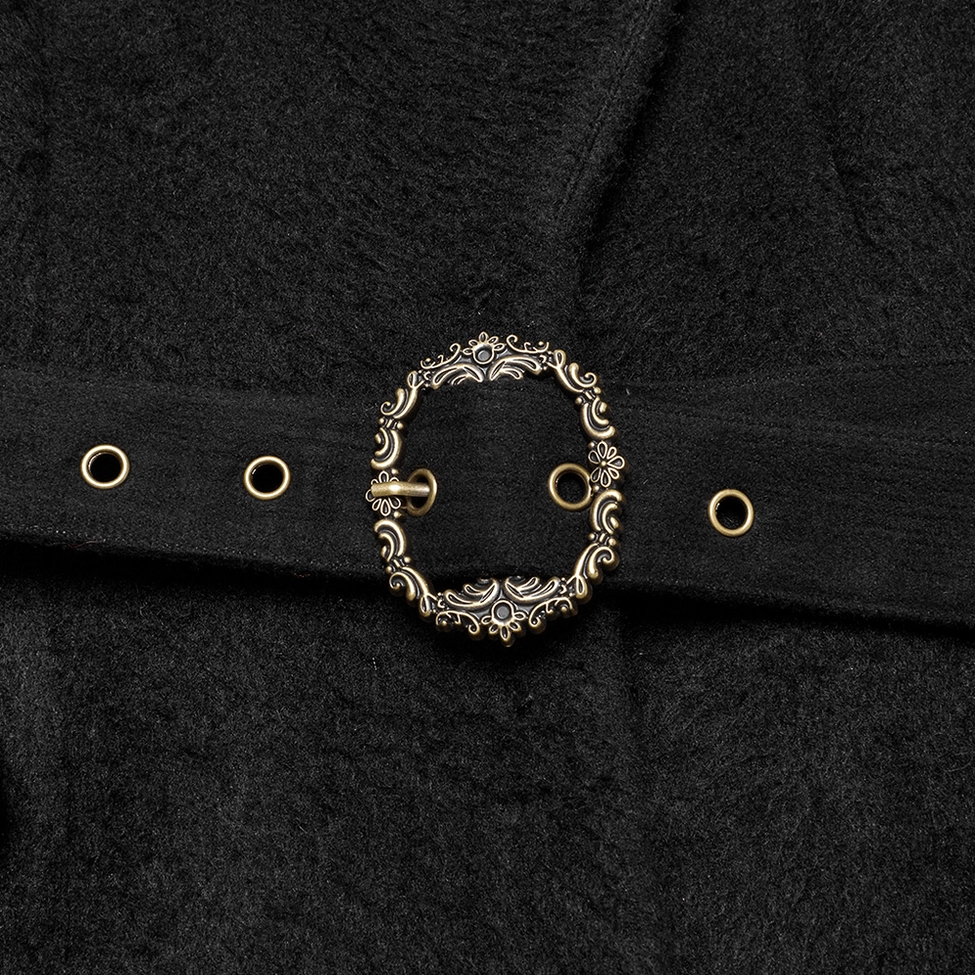 Ornate vintage metal buckle and brass grommet hardware detail on black gothic coat's waist belt