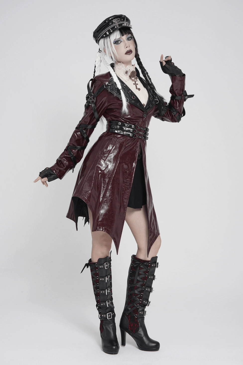 Women's burgundy gothic harness coat construction showing internal lining and seam quality of synthetic leather exterior