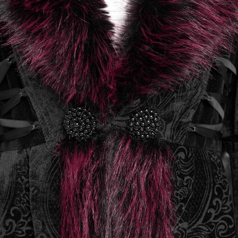 Close-up detail of burgundy faux fur collar and front closure area showing decorative beaded accents and velvet fabric texture