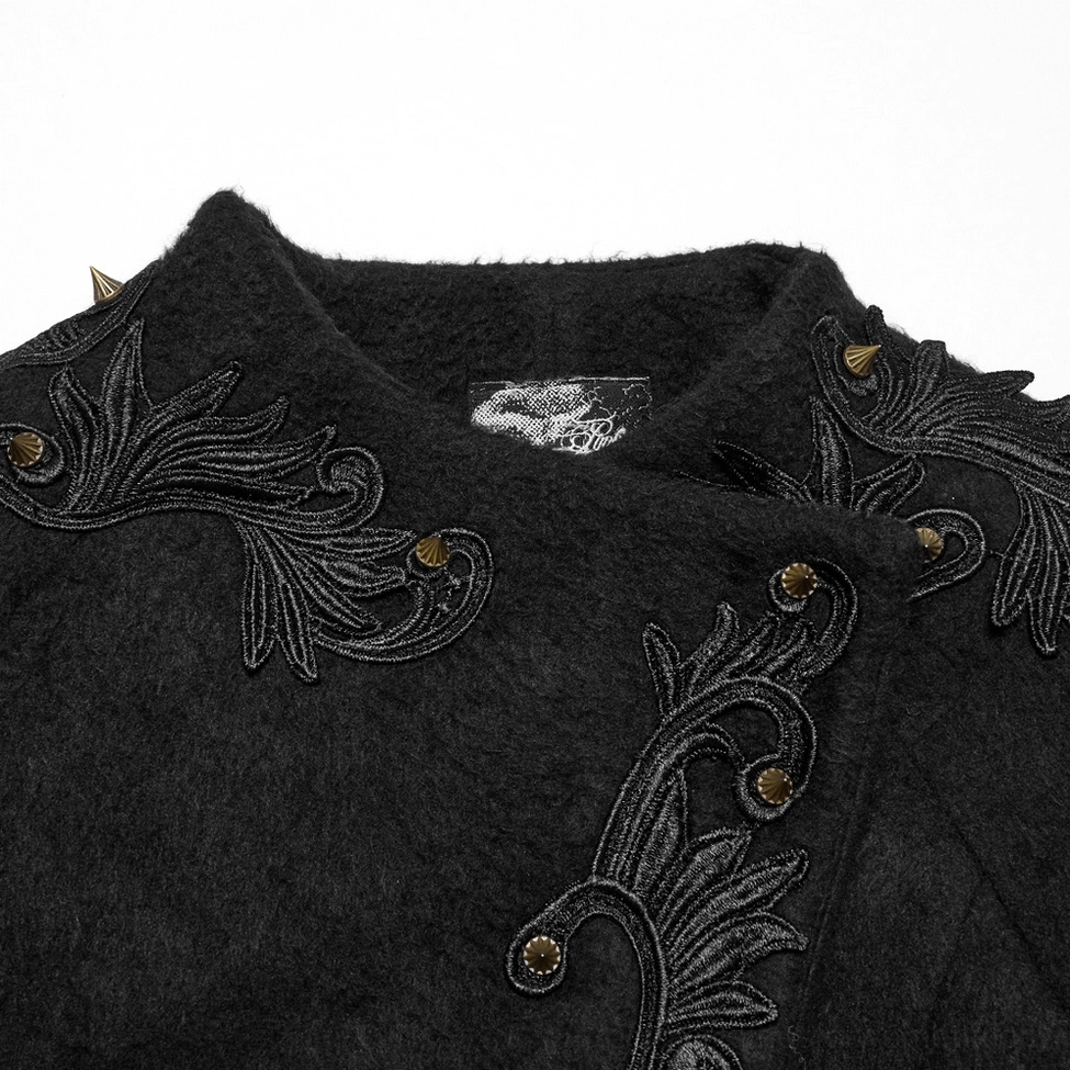 Close-up detail of black gothic coat collar and upper section featuring vintage embroidery, spike trims, and plush wool texture