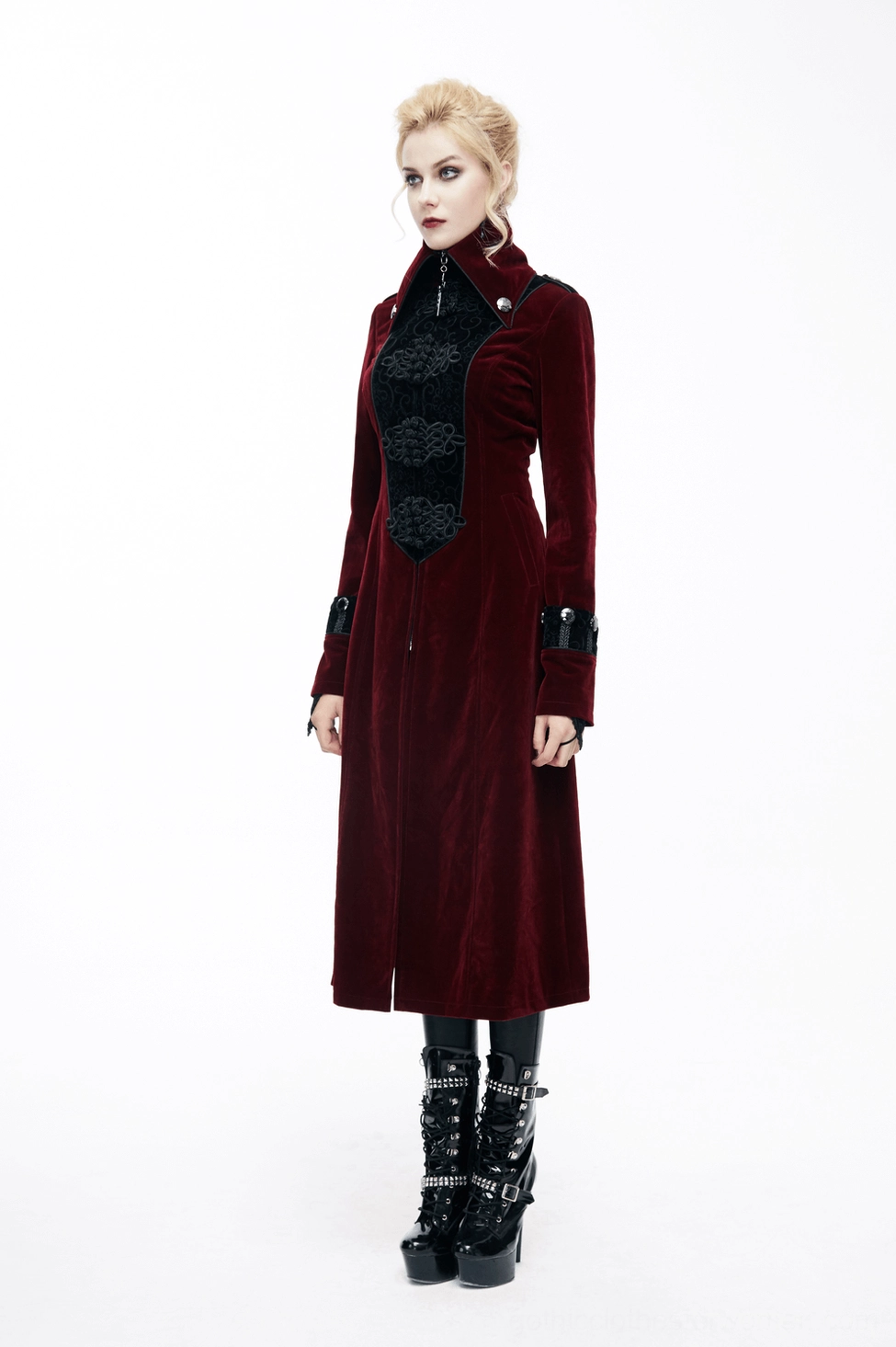 Black embroidered gothic coat front panel close-up - intricate embossed design, decorative gem accents, velvet texture detail