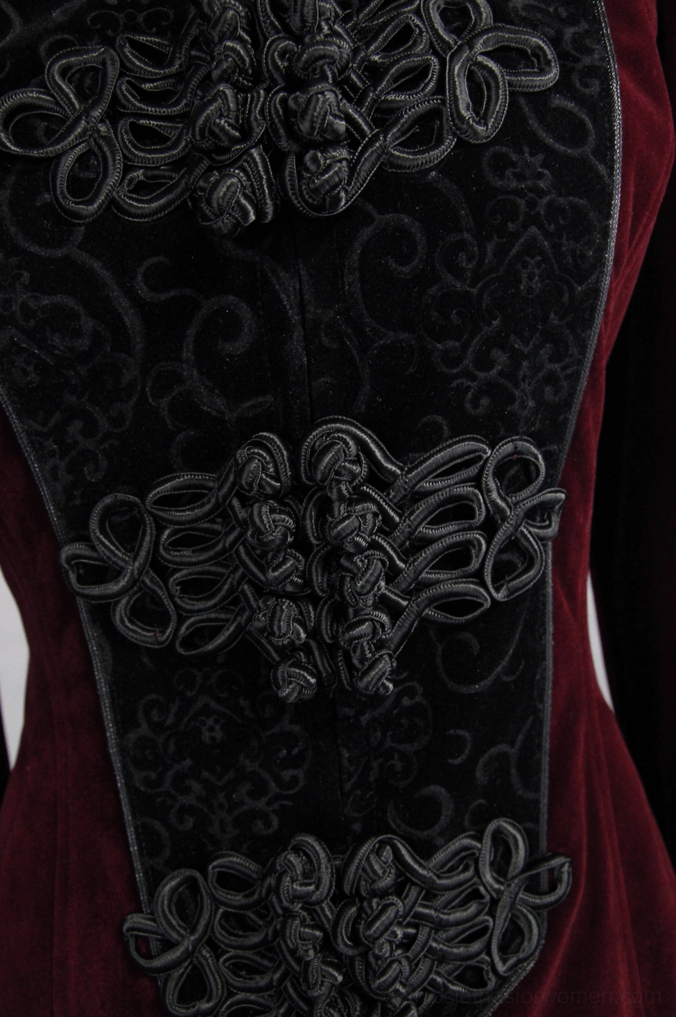 Detailed close-up of gothic coat intricate black corded embroidery - knot-style patterns on velvet front panel showing craftsmanship