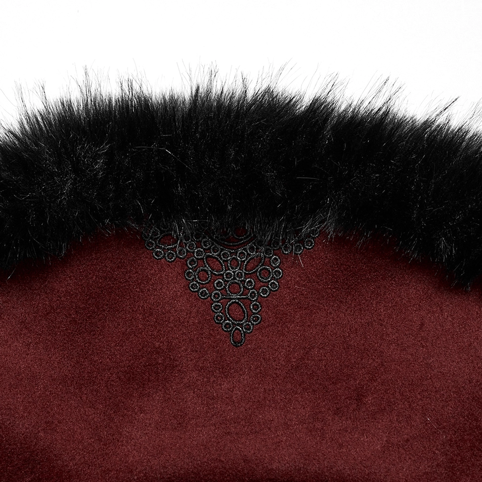 Detailed macro shot of embroidered collar with intricate black pattern work, black faux fur trim, and decorative stitching on wine red