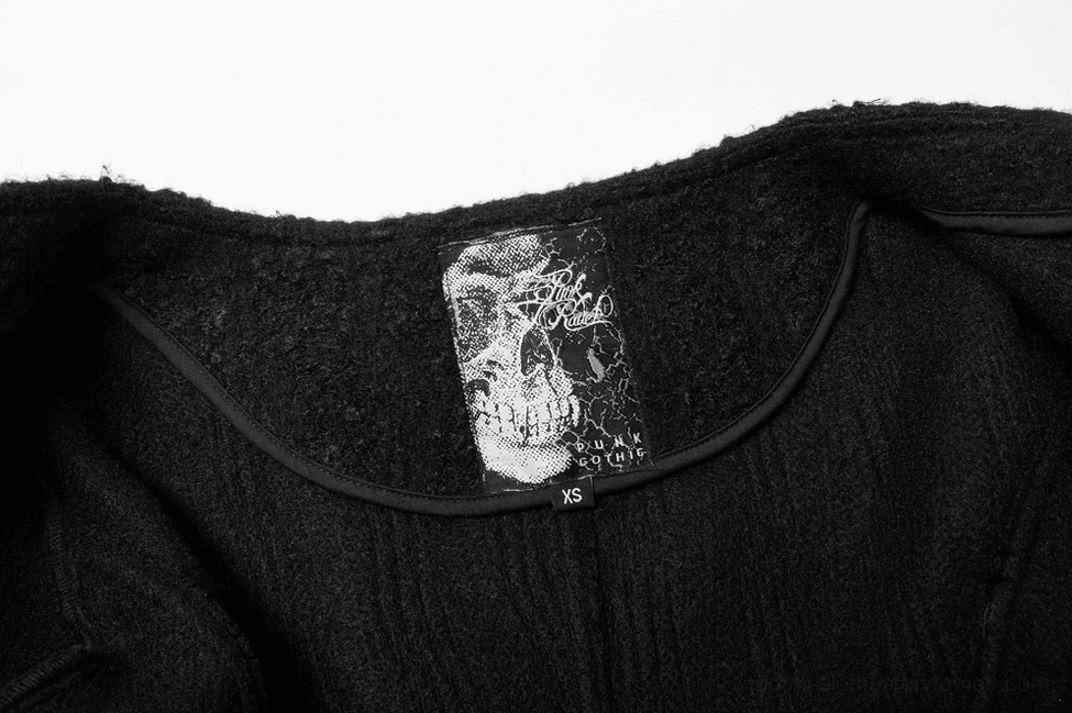 Close-up of gothic coat skull brand label and premium woolen fabric texture
