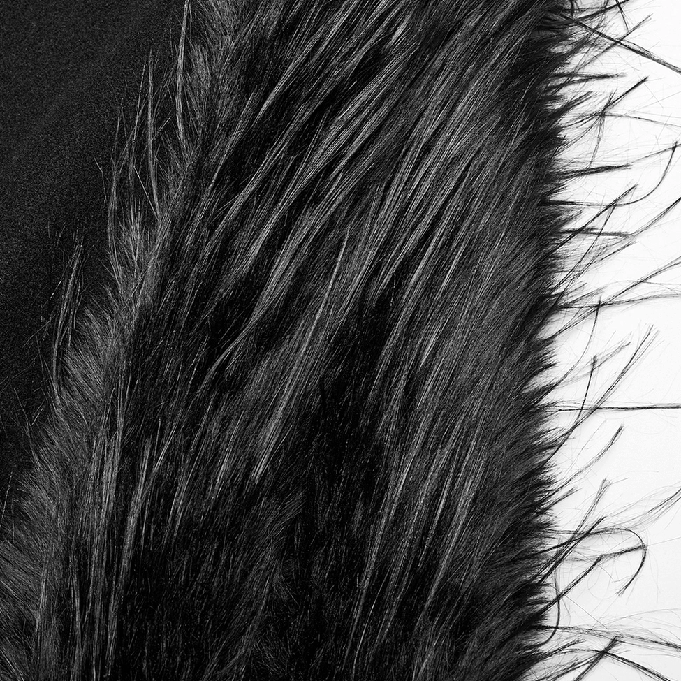 Textured close-up of fluffy black faux fur trim and accent on gothic coat