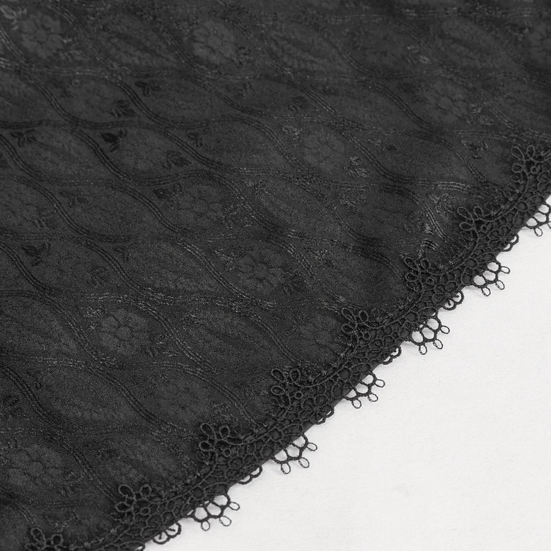 Close-up detail of gothic coat hem trim showing crocheted lace edge and jacquard fabric