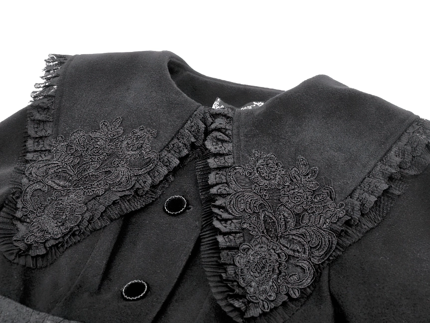 Close-up detail of embroidered lace collar with ruffled trim and decorative fabric buttons on gothic coat