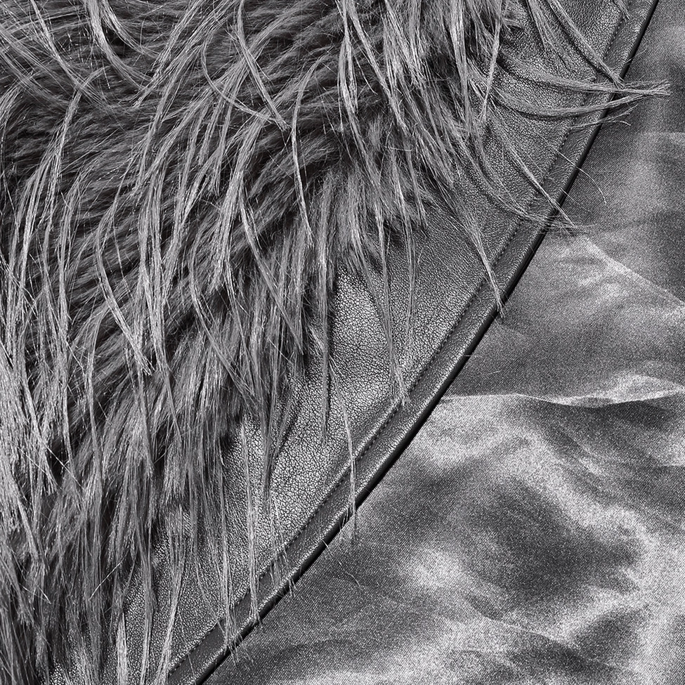 Close-up detail of stitched leather seam on faux fur gothic coat showing mixed material craftsmanship