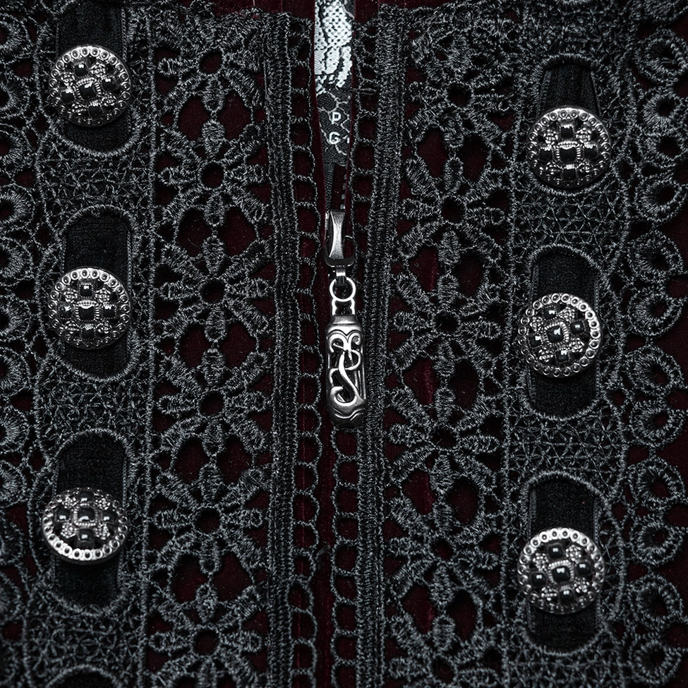 Close-up detail shot of black floral lace panel and ornate metal buttons on gothic coat front