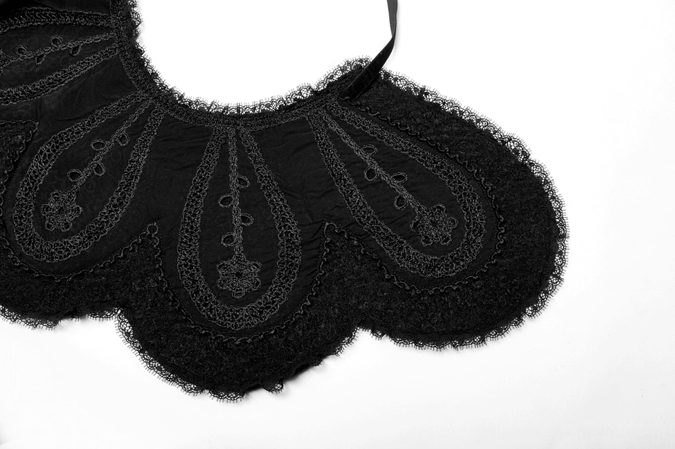 Black gothic Victorian coat detail of rope-bound fur pom-pom and accent features