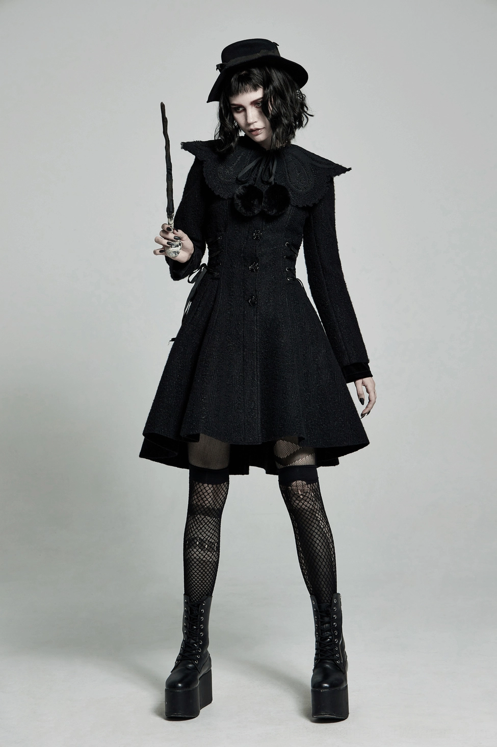 Black gothic coat detail showcasing premium fabric construction and seam craftsmanship