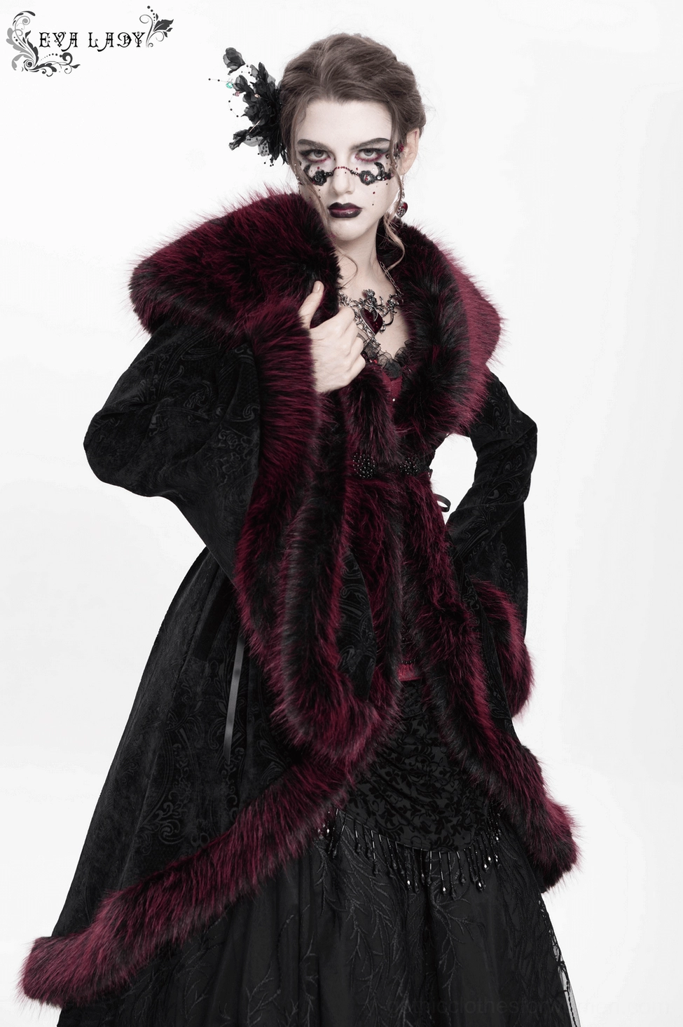 Side profile view of black velvet gothic coat worn by model showing silhouette, side lace details, and flowing drape of premium fabric