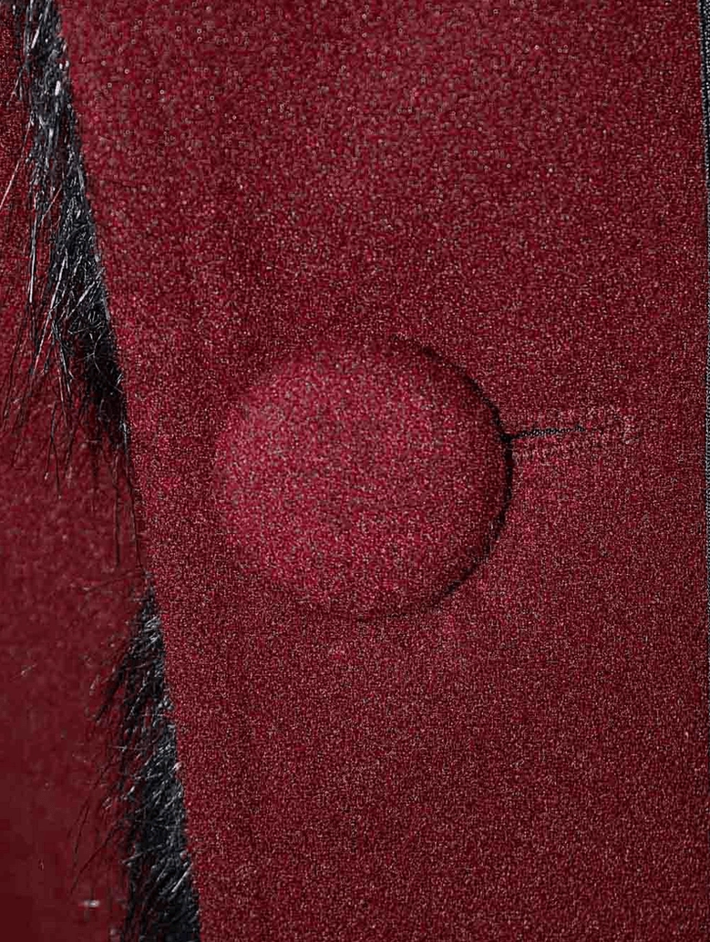 Detail shot of wine red gothic coat sleeve and buckled cuff showing extended sleeve design
