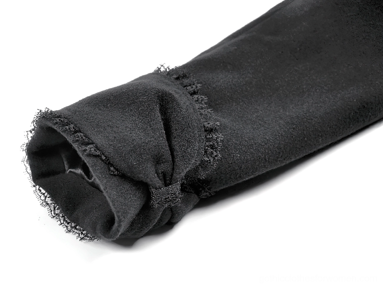 Close-up view of frilled lace trim and tailored sleeve cuff on victorian gothic black coat
