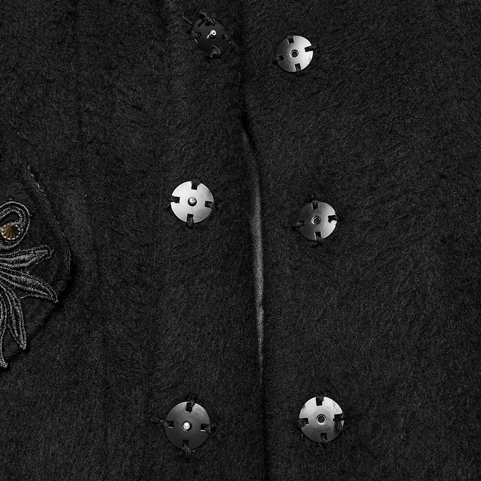 Coat closure mechanism detail showing metal snap buttons and embroidered leaf motif on black gothic coat fabric