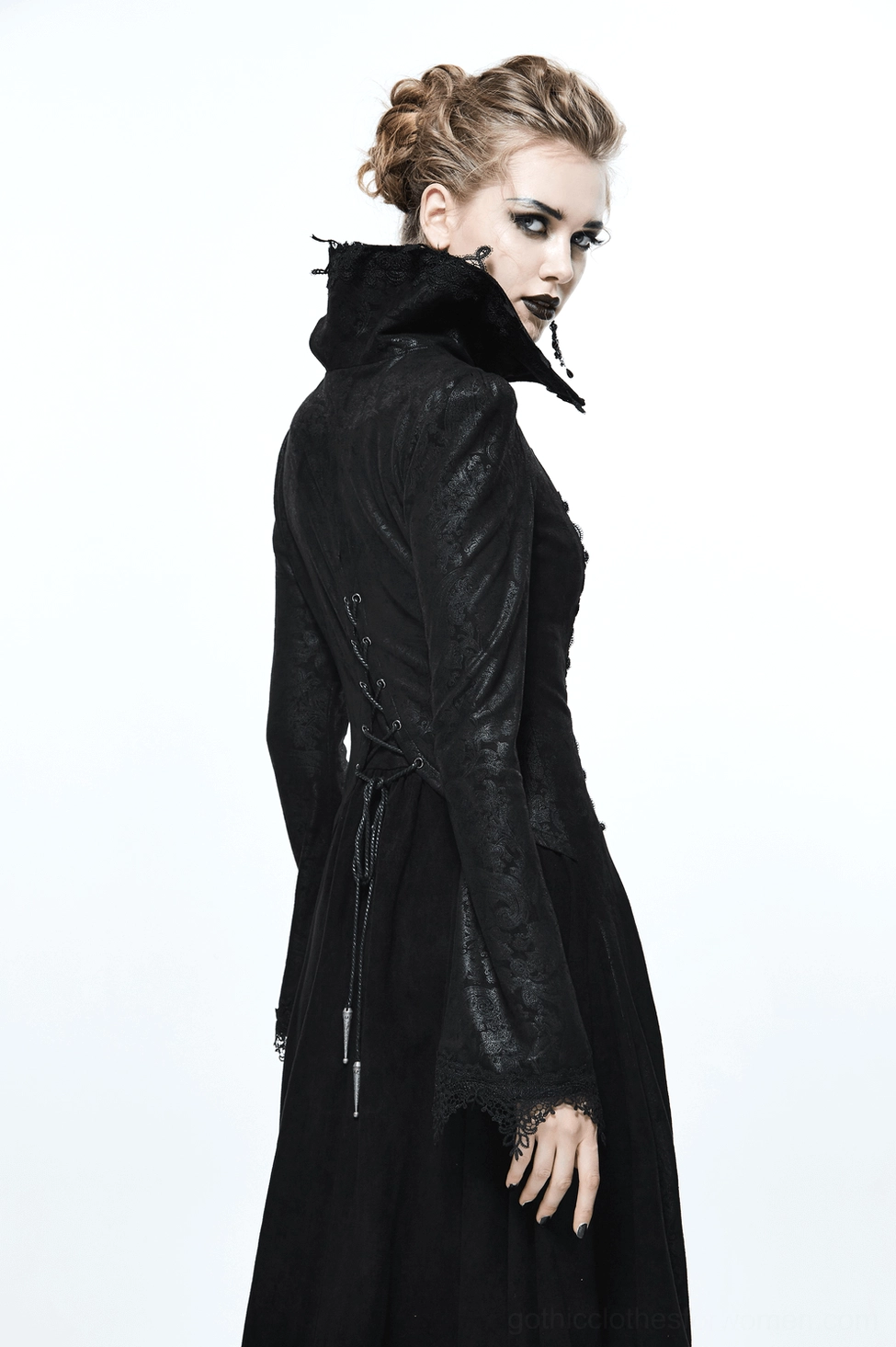 Black embossed gothic coat showing flowing train hem, velvet lower panel contrast, full-length sleeves, and dramatic silhouette