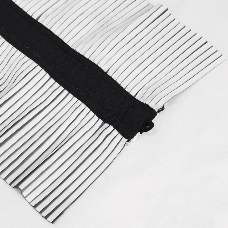 Close-up side view of gothic collar fastening system showing hook-and-loop closure on pleated fabric