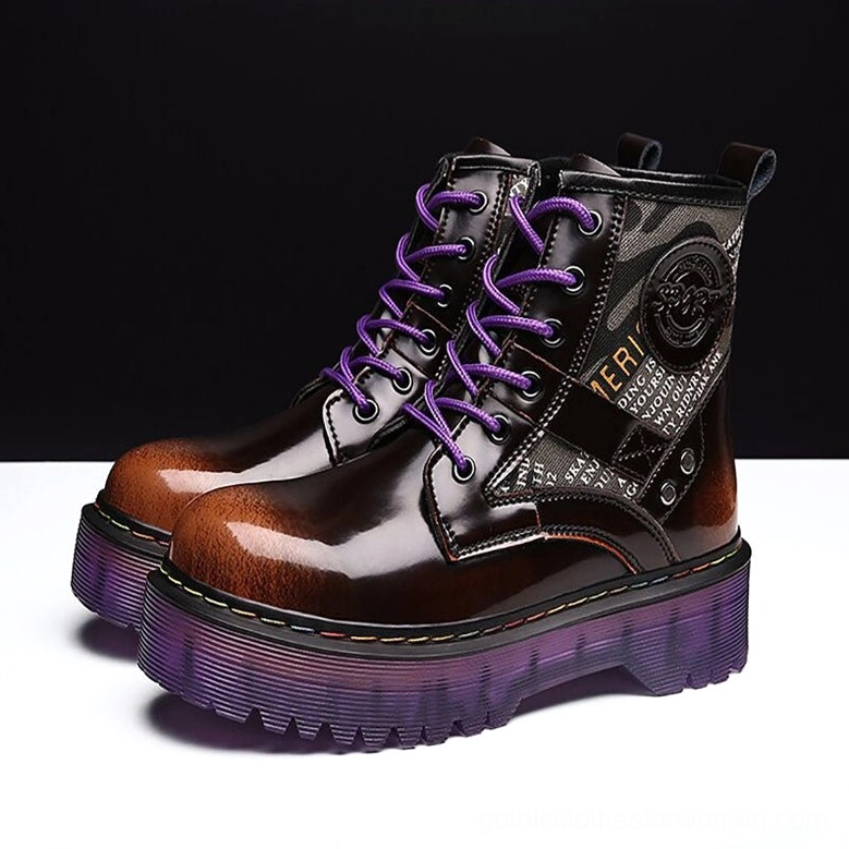 Pair of black and brown gothic combat boots with purple platform soles, front low-angle view