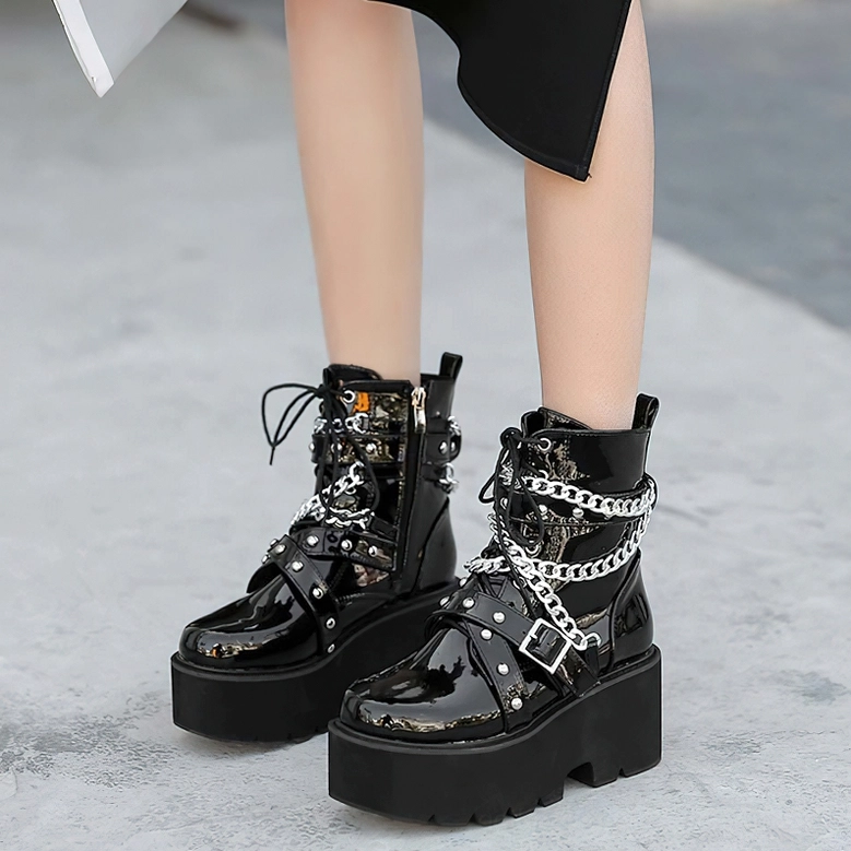 Female model wearing dark gothic platform combat boots with side zipper, outdoor styled shot showing street alternative fashion