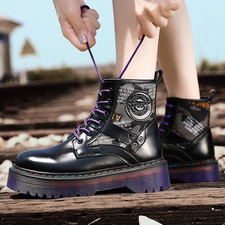 Gothic combat boots styled on female model in urban street setting, outdoor fashion photography