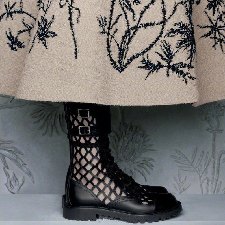 Black leather gothic combat pumps styled with embroidered skirt side profile view showing dual buckles and platform height