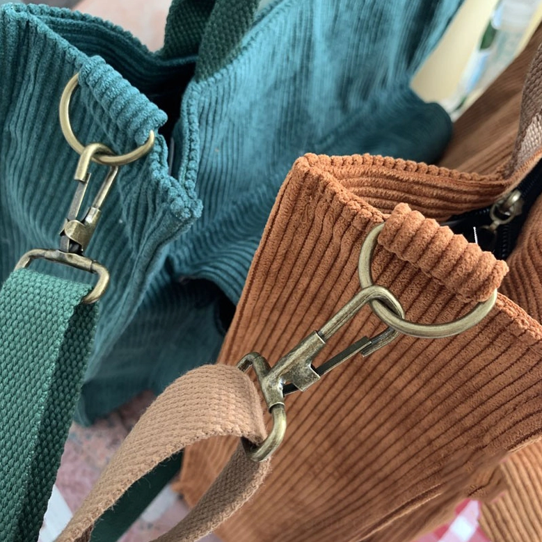 Women's gothic corduroy tote bag interior view displaying multiple pockets, cell phone holder, zipper pocket, and key chain holder organization