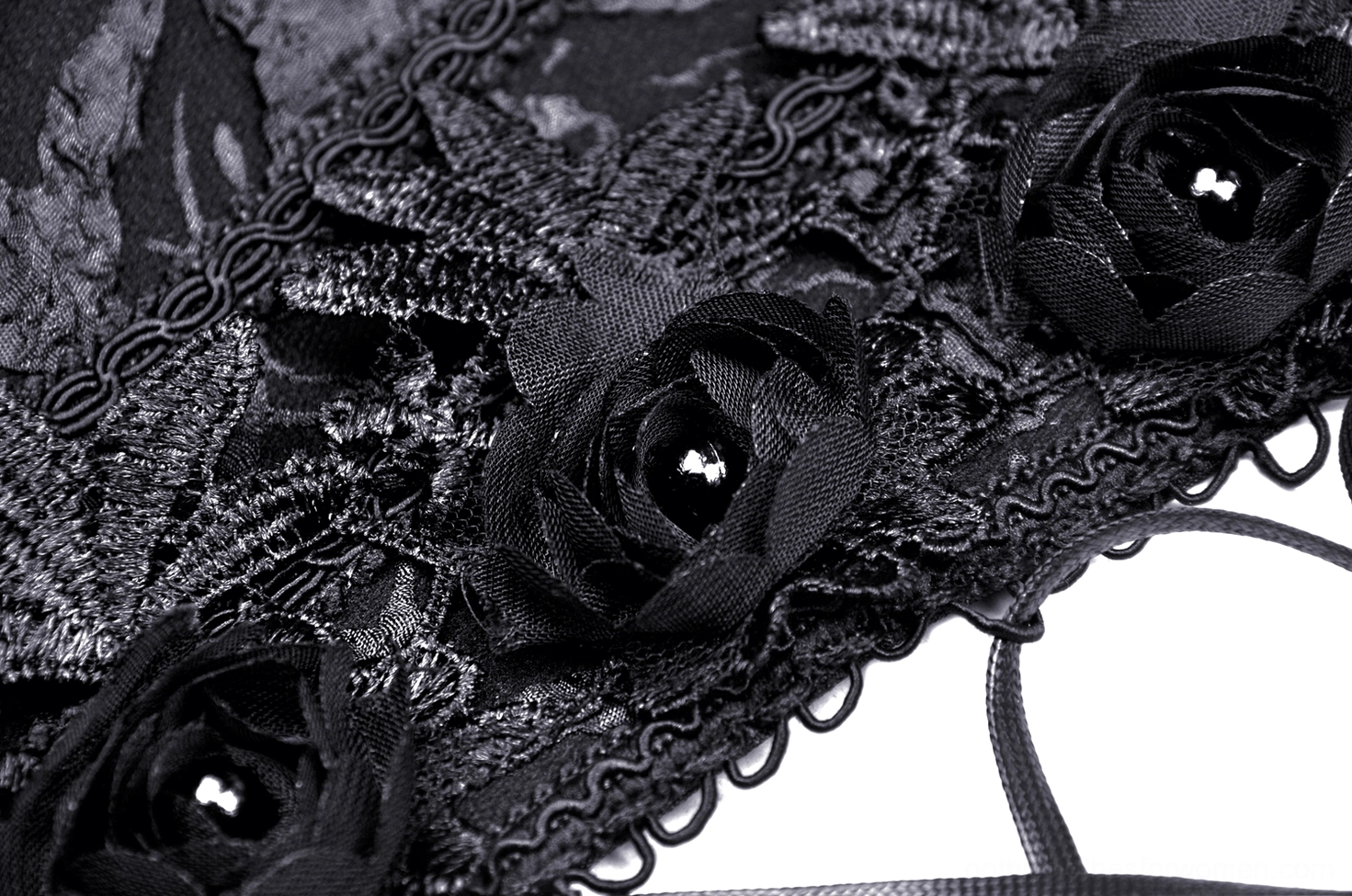 Close-up detail of 3D satin rose ornaments with bead centers and scalloped lace trim on gothic corset