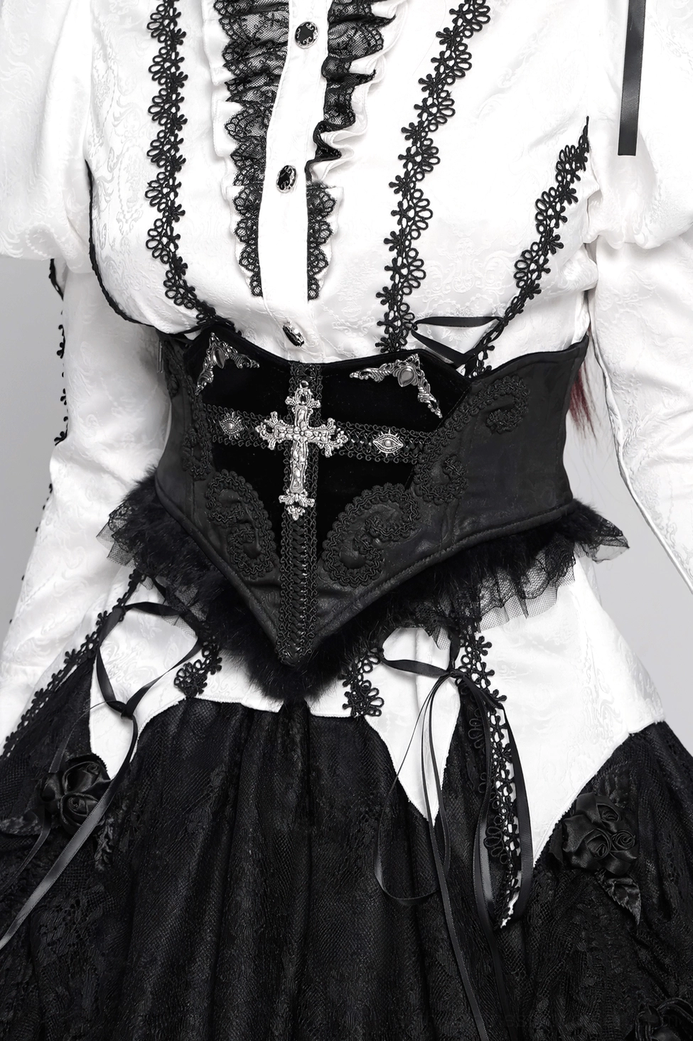 Black lace corset belt back lacing system detail product shot showing adjustable eyelet construction, velvet lace straps, and Victorian-inspired design elements