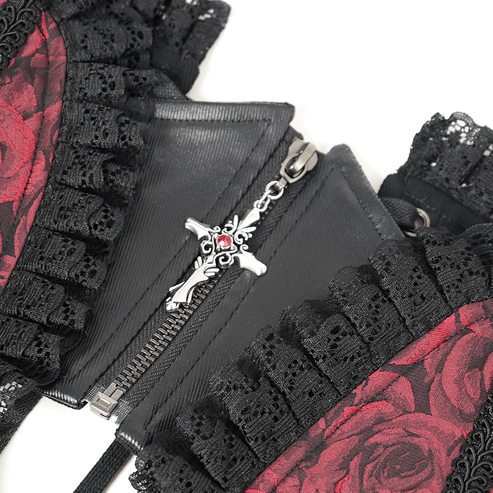 Close-up detail of cross pendant zipper pull on gothic corset belt with black lace ruffle trim