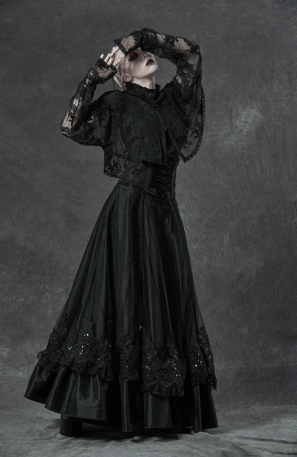 Black gothic corset belt showing dual closure system with front drawstring lacing, eyelet adjustments, and decorative floral embroidery pattern