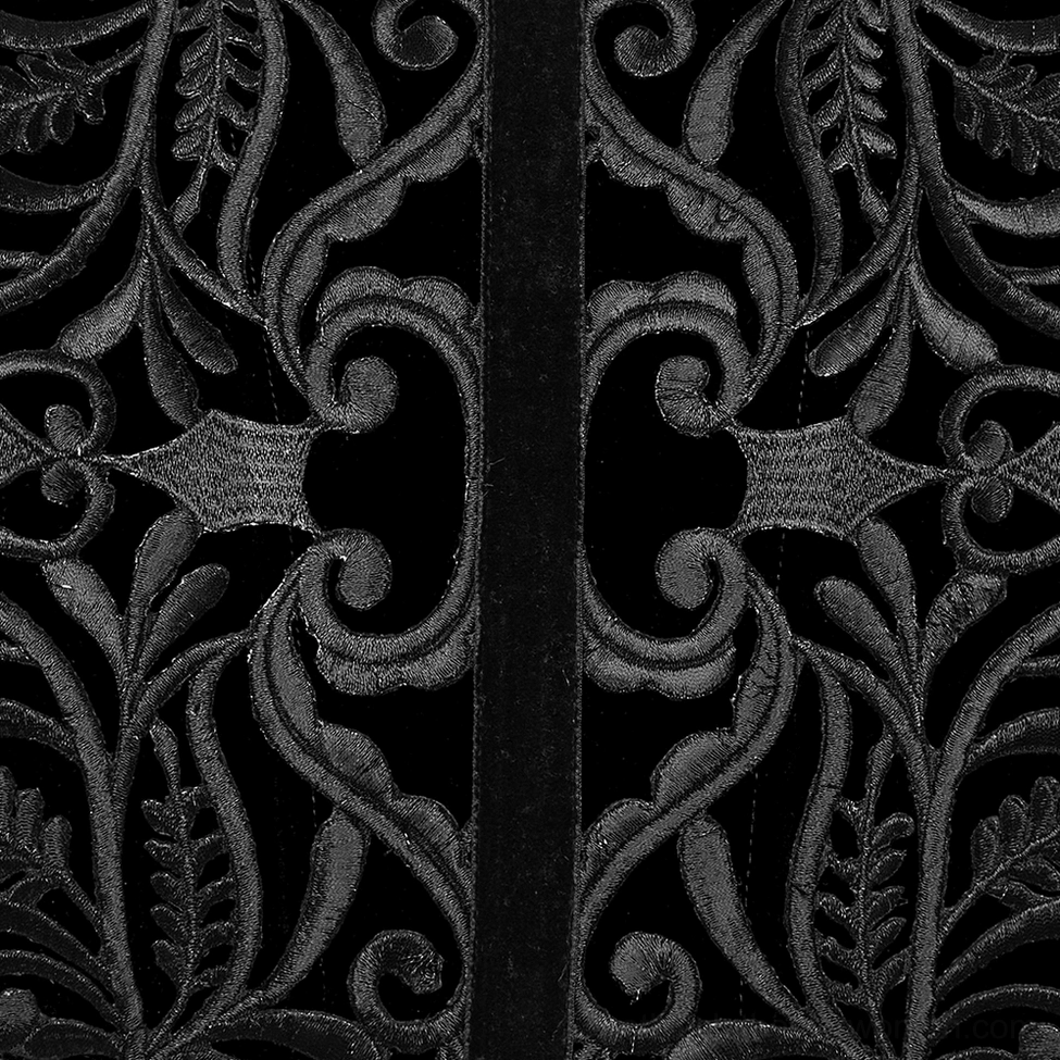 Close-up extreme detail of black velvet gothic corset belt showcasing intricate baroque vine stitching